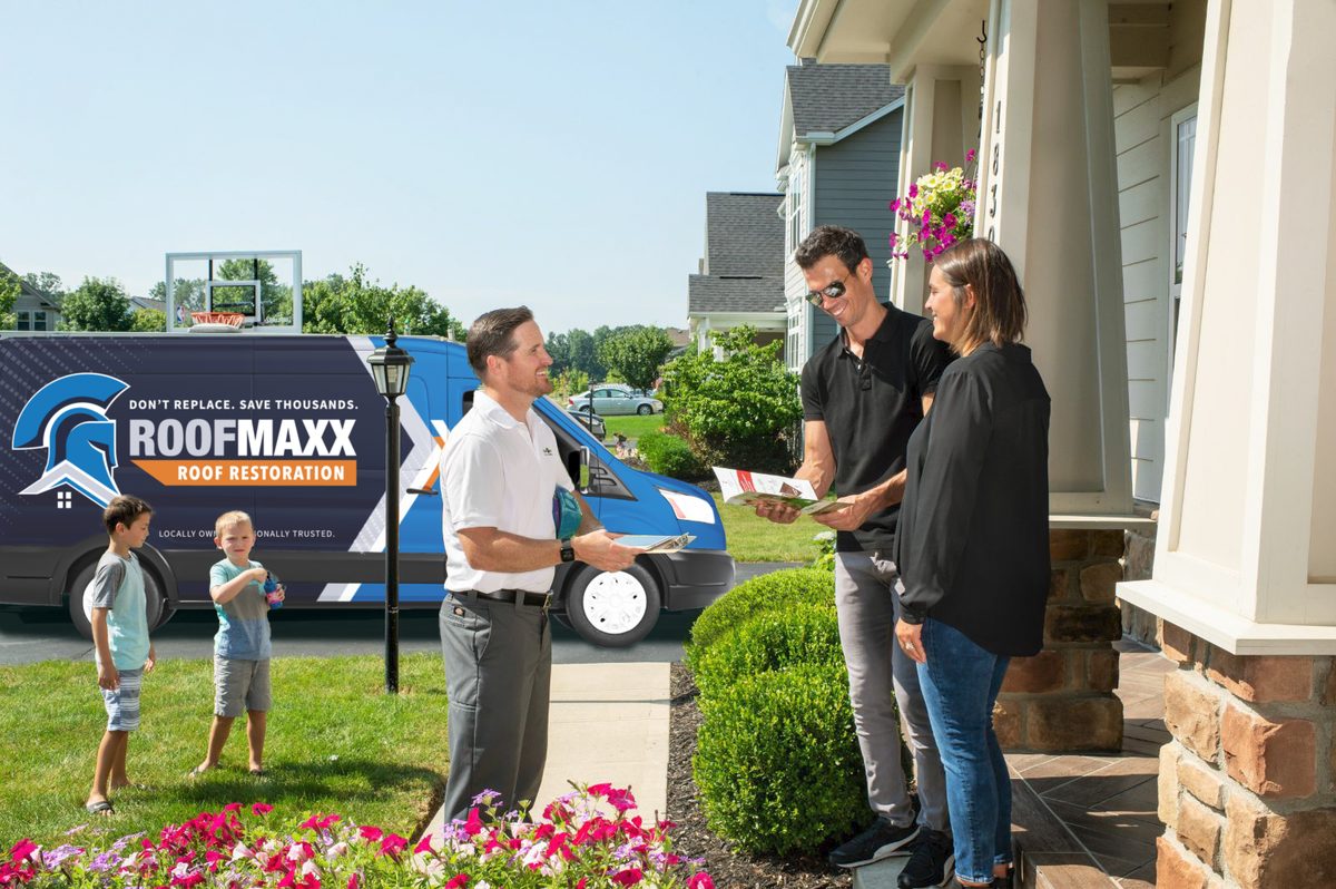 Roof Maxx van parked at a family home with kids playing